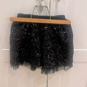 Black sequin skirt size 6X with knit elastic waist and chiffon ruffle at bottom